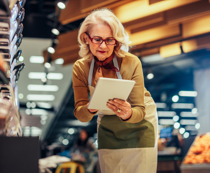 elderly woman in a grocery store with a notepad
